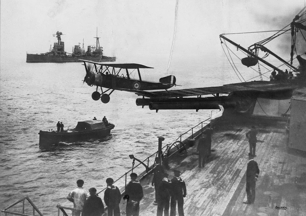 A Sopwith 1 1/2 Strutter biplane aircraft taking off from a platform built on top of HMAS Australia’s midships “Q” turret, 1918.